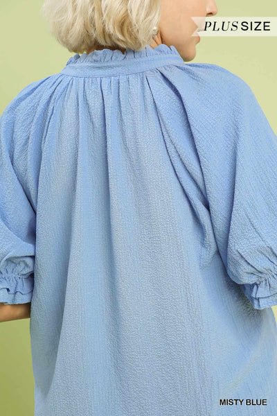 plus model wearing a blue v neck blouse