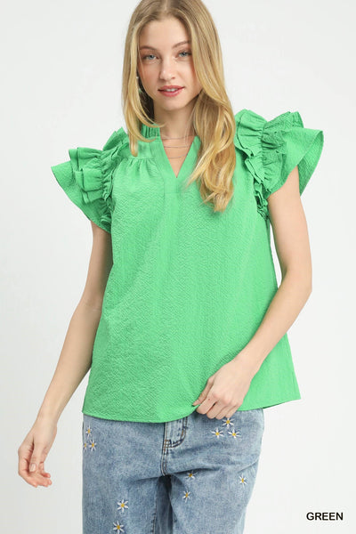 model wearing green v neck top & jeans
