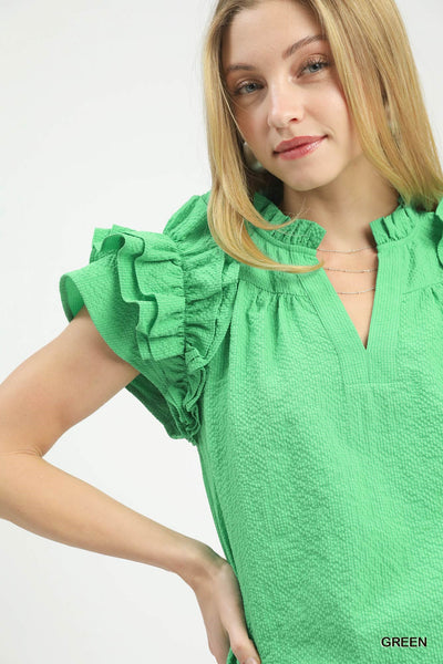 model wearing green v neck top & jeans