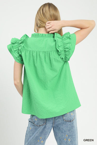 model wearing green v neck top & jeans