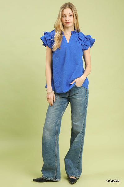model wearing blue v neck top & jeans