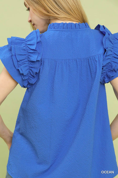 model wearing blue v neck top & jeans