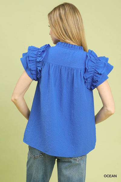 model wearing blue v neck top & jeans
