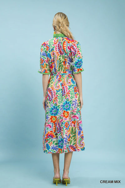 model wearing a cream floral dress with a mint background