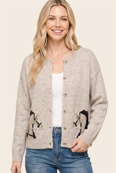 model wearing a white shirt and blue jeans with a taupe horse themed cardigan