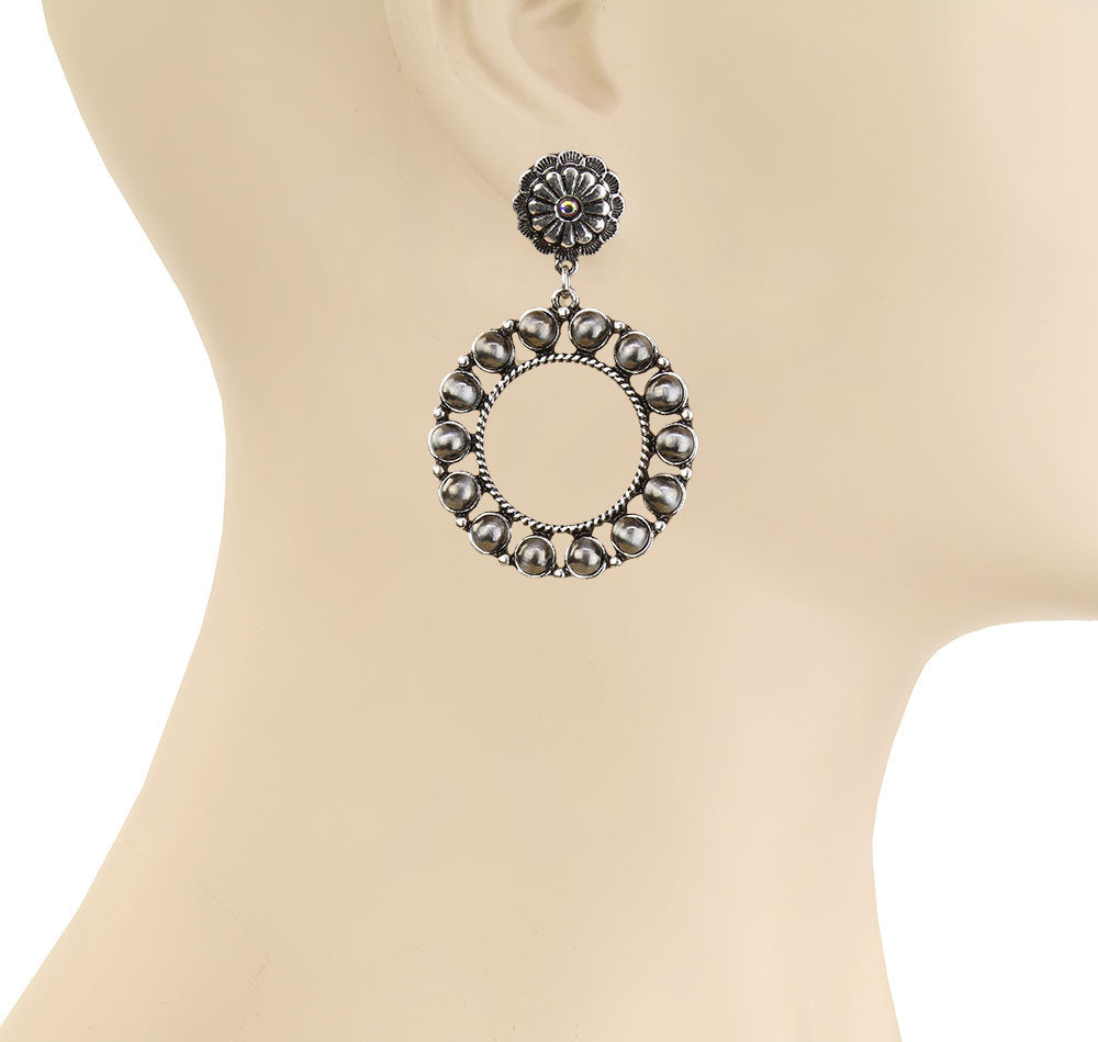 Decorative earring on a mannequin.