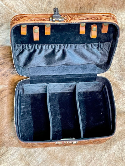 Open jewelry case with compartments on a textured surface