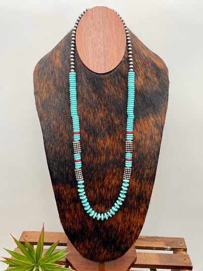 Necklace with turquoise beads on a wooden mannequin against a white background