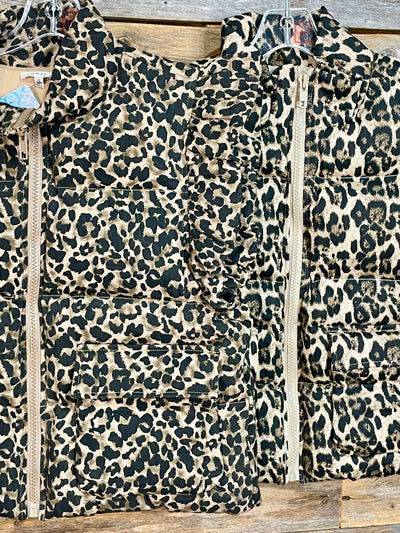Leopard print jacket with a zipper on a wooden surface
