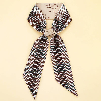 Black and white zigzag patterned scarf on a beige background