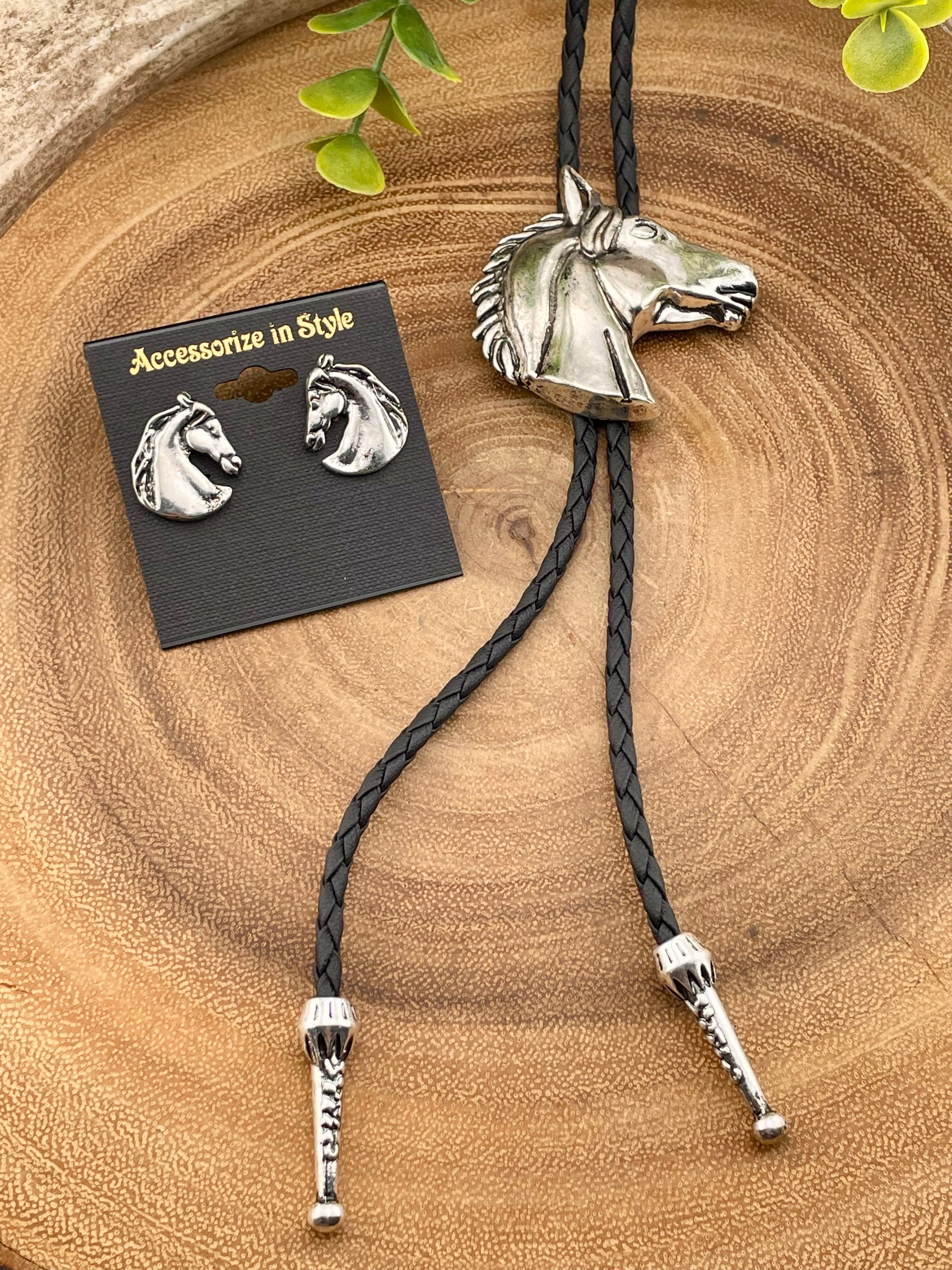 Horse-themed bolo tie and earrings on a wooden surface with 'Accessorize in Style' card.