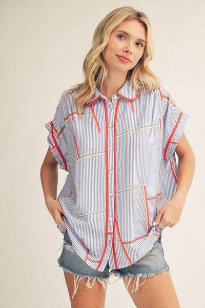 model wearing geometric print top with cutoff denim shorts