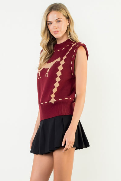 Woman wearing a burgundy sleeveless top with a black skirt on a white background