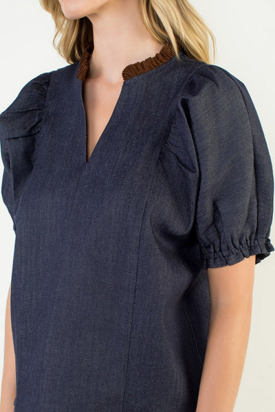 Navy blue blouse with ruffled sleeves on a white background