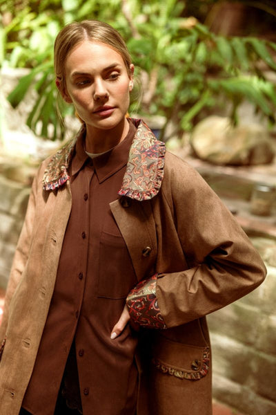 woman modeling a brown shirt with jacket outside