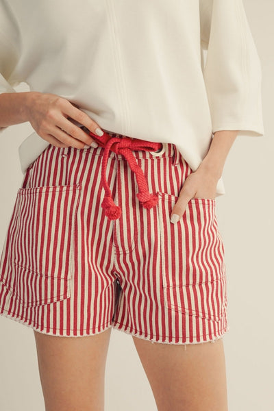 model wearing red striped shorts