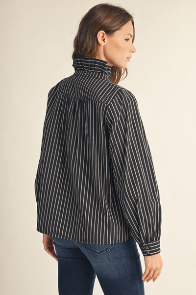model wearing ruffle collar black & white striped blouse and jeans shown from the back