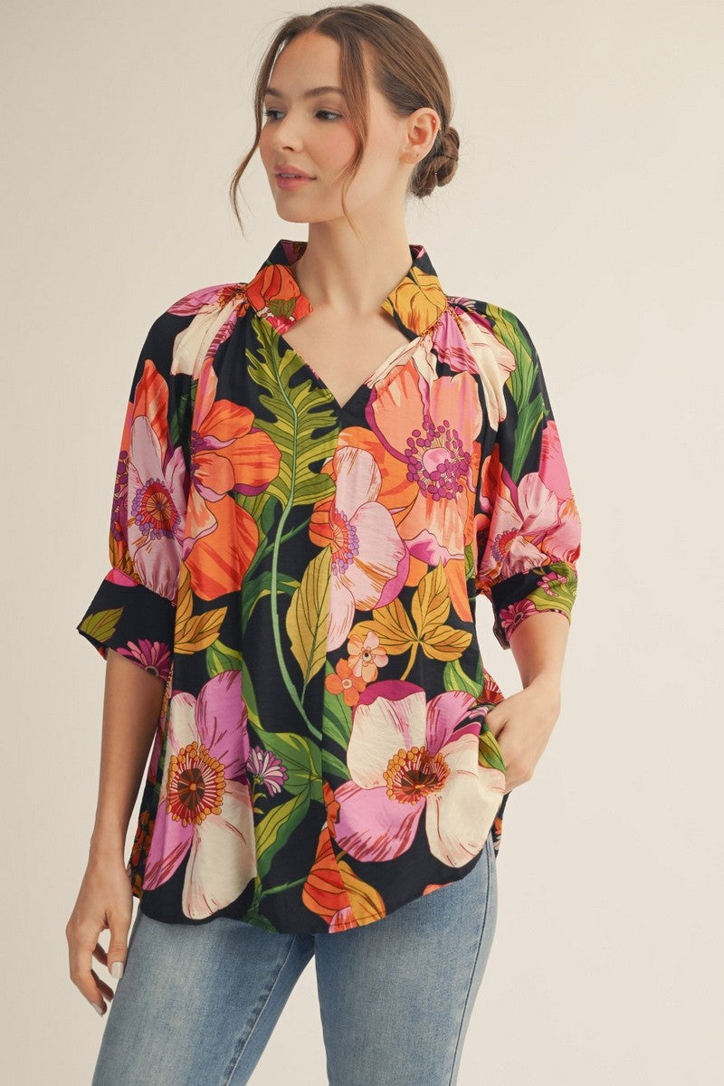 model wearing a floral top & jeans