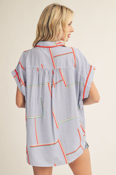 model wearing geometric print top with cutoff denim shorts