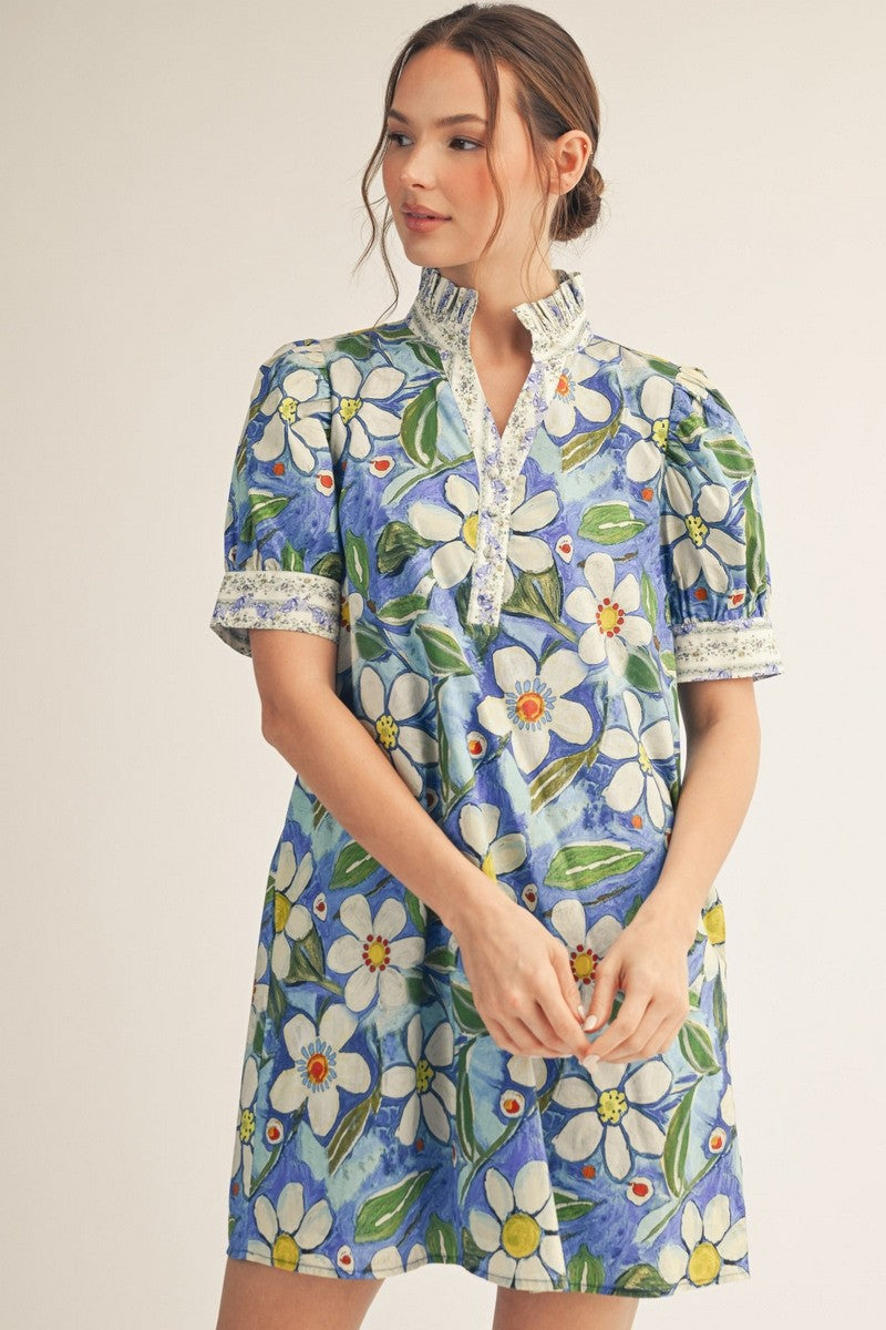 model wearing a a blue floral shift dress
