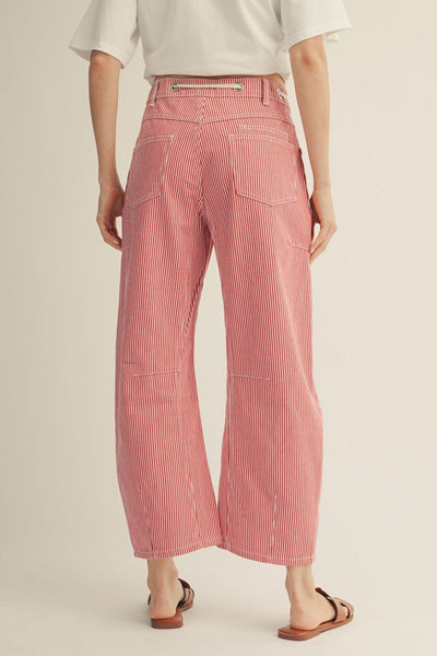 back of model wearing a red striped drawstring pants with a tshirt