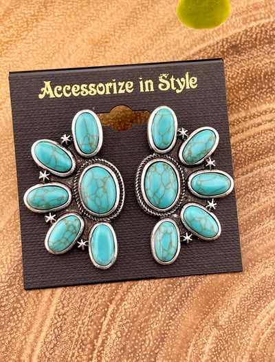 turquoise earrings on a wooden background