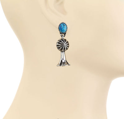 turquoise dangle earrings on a mannequin