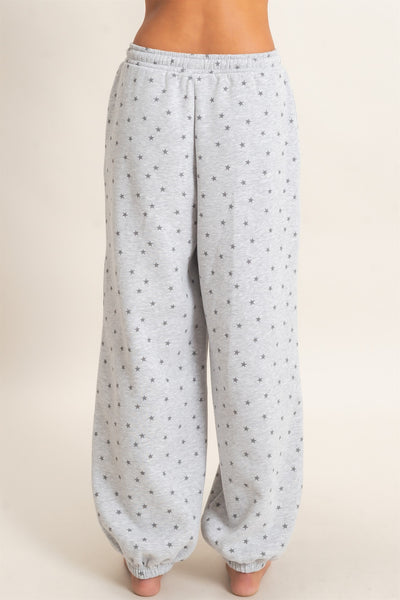 back of a model wearing gray star print joggers