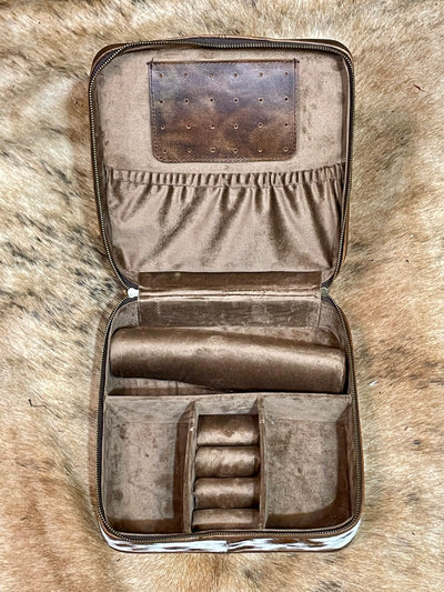 Open leather jewelry case with compartments on a fur background