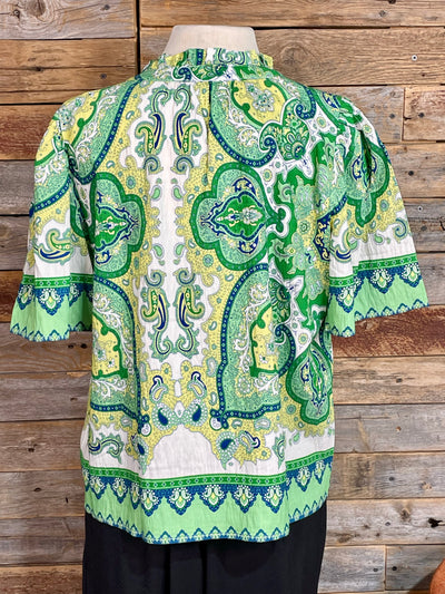 Green and white patterned shirt on a wooden background