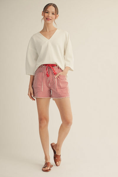 model wearing red striped shorts