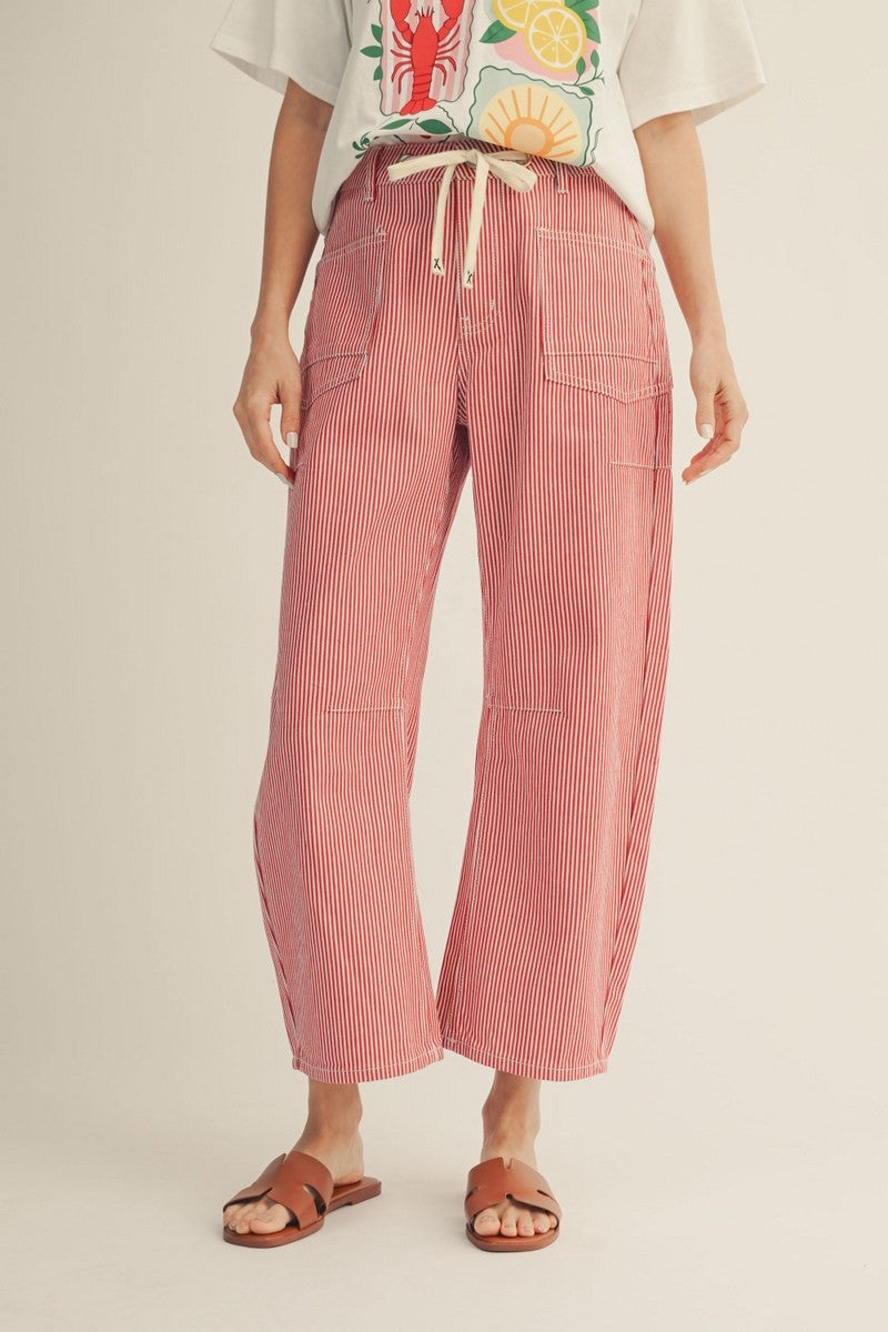 model wearing a red striped drawstring pants with a tshirt