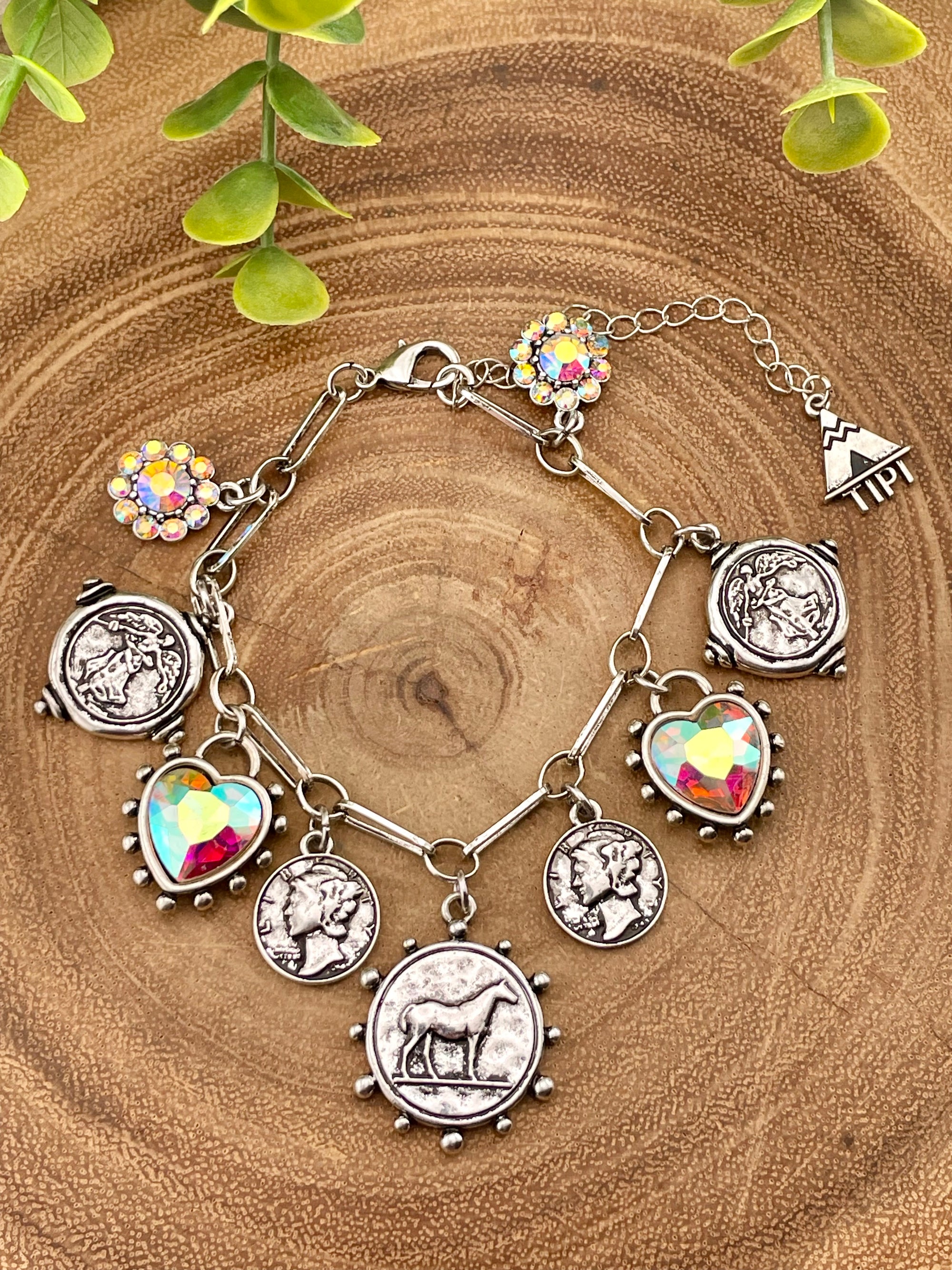 Coin charm bracelet on wooden background 