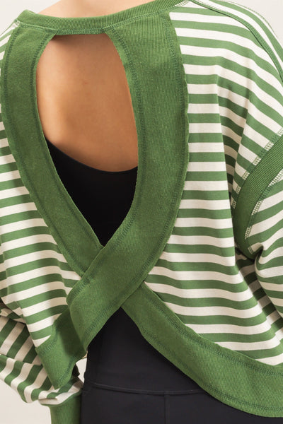 close up of green striped open back sweater