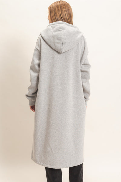 back of model wearing a black outfit with oversized long gray coat
