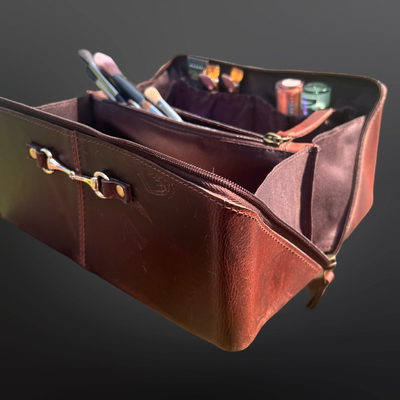 Brown leather bag with compartments on a dark background