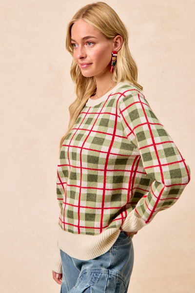 Woman wearing a plaid sweater with a beige background