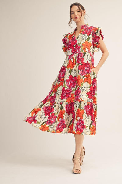 model wearing a pink & orange floral dress with a light background