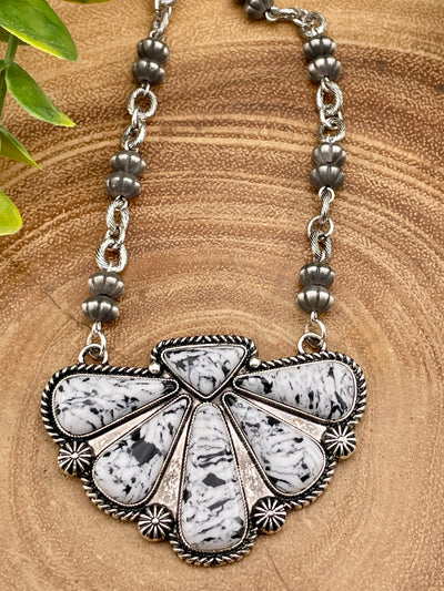 Necklace with a decorative pendant on a wooden surface