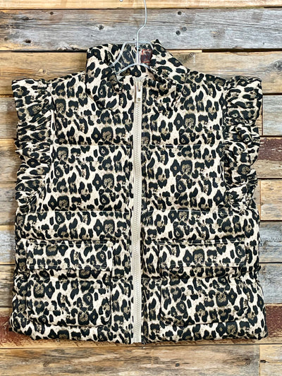 Leopard print puffer jacket on a wooden background