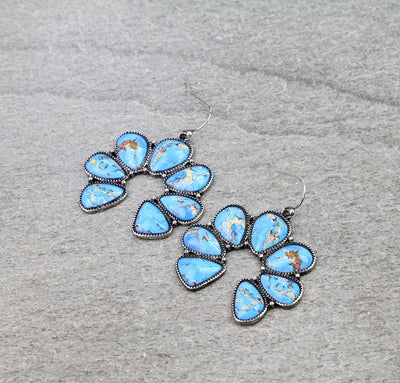 Turquoise Naja earrings on a gray background