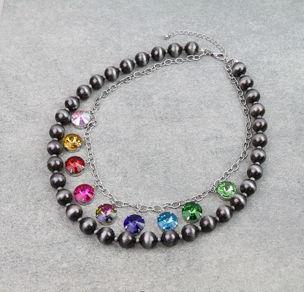 Double strand silver necklace with rhinestones on a gray background.