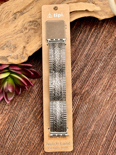 Watch band with geometric pattern on a cardboard packaging against a wooden background