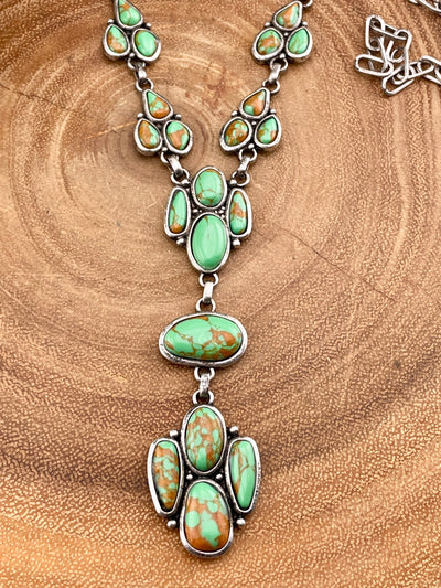 close up of turquoise necklace on wooden background