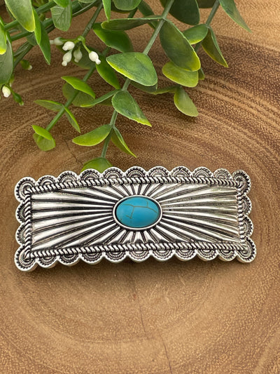 silver & turquoise hair clip on a wooden surface