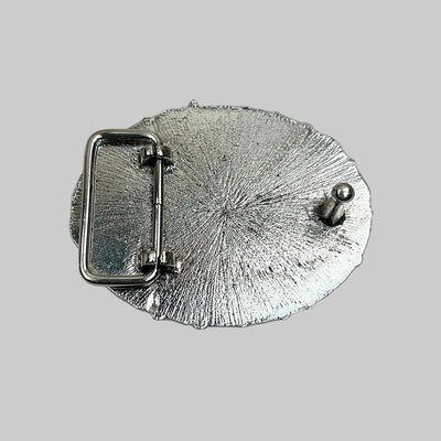 Silver belt buckle on a textured gray background