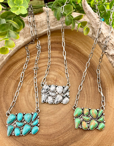 Three cluster necklaces shown on wooden background