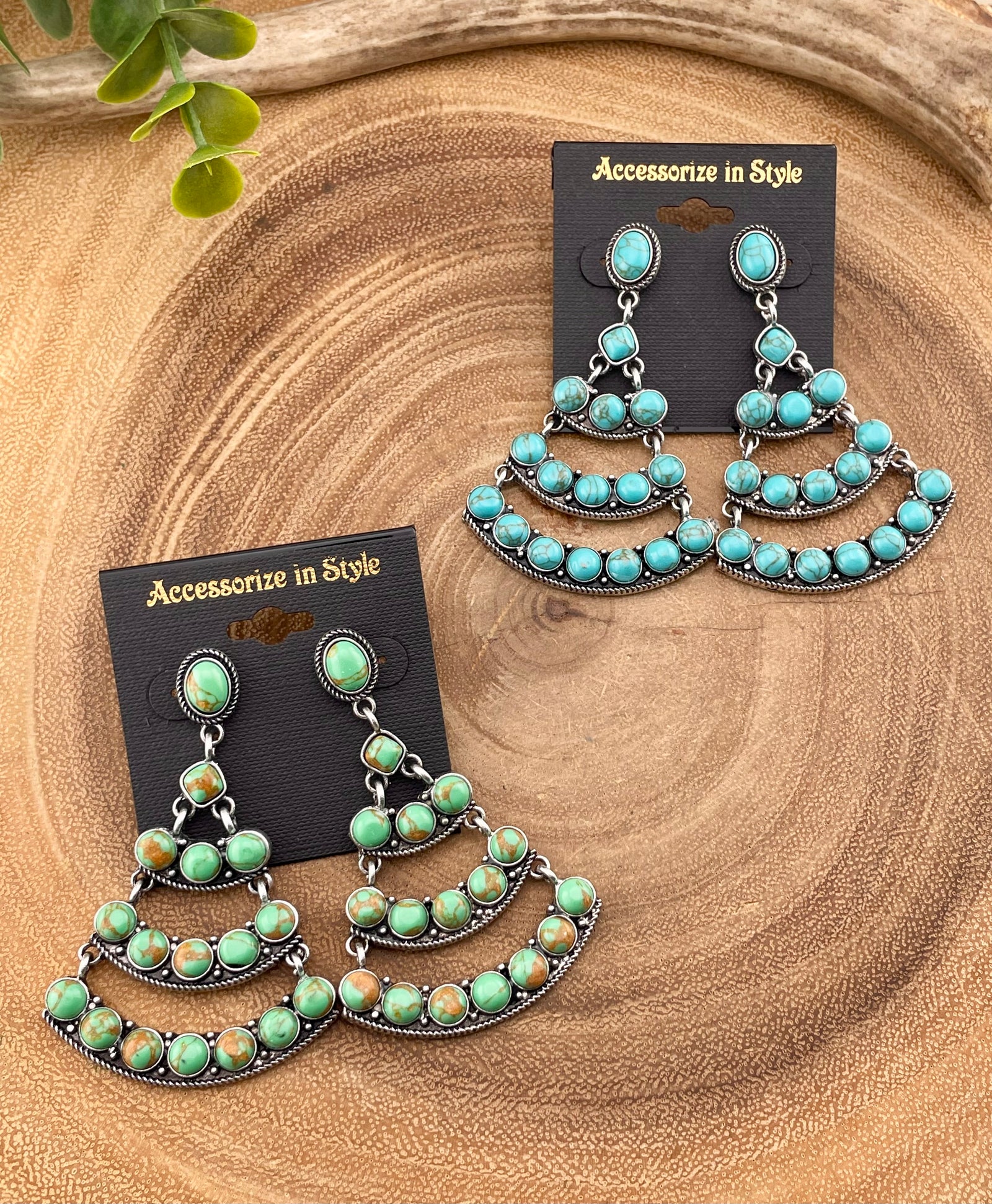blue & green chandelier earrings on a wooden background