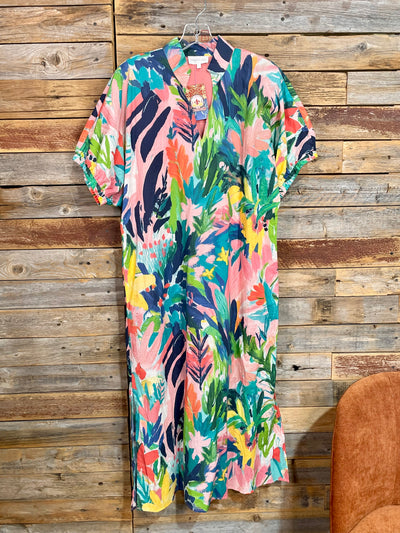 Colorful floral dress hanging on a wooden wall