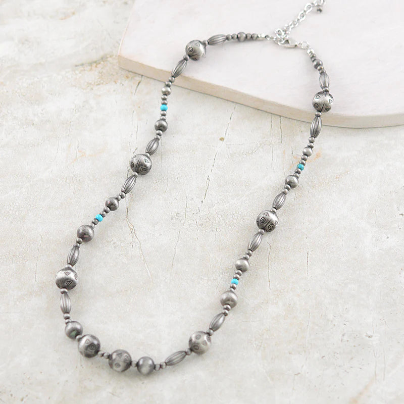 turquoise & silver bead necklace on white background
